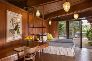 The guest bedroom in the main house holds a built-in desk that was installed by Jay's father, who took inspiration from the lines and shapes of the rest of the house. 