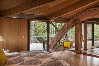 One of the brick arches connects to the master bedroom, which has an accordion door installed by Jay's father that can shut off one side of the room from the rest of the living space.