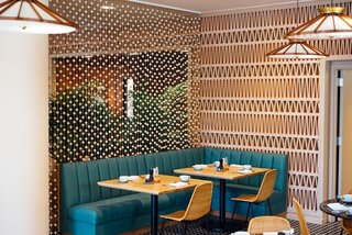 Along with serving creative craft cocktails from the bar, the Hideout restaurant offers Pacific Rim and American comfort food. Jewelry designer Anna Korte of AK Studio made this custom curtain specifically for the project. 