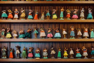 Standing behind the reception desk is a lighthearted installation designed by the OMFGCO Art Department. It features 70 vintage dashboard hula nodders.