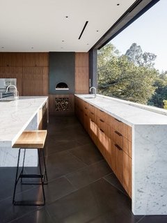 The kitchen features a pizza oven by Mugnaini.