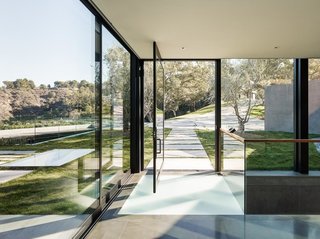 "Given the natural beauty of the site, I understood that it would be important to make the relatively large house as diminutive as possible," explains Walker. "To achieve this, I placed two-thirds of the program below grade, and much of it under a vegetated roof. Because the house is sited on a ridge, the lower level was still able to have commanding views and vistas from nearly every window."