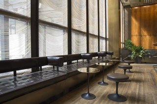 Custom side tables and stools by Eero Saarinen lined the bar, adjacent to the Grill Room.