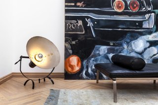 Vintage details, like this metal floor lamp, contrast with parquet floors in a subtle nod to an industrial aesthetic.