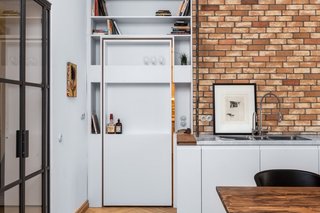 A view of the pivoting shelf door from the kitchen and dining area.