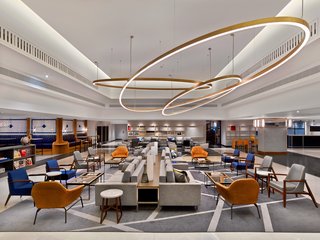 The Largest Hotel in Paris Gets a Midcentury Modern Update - Photo 3 of 5 - A reinterpretation of the traditional hotel lobby, The Hub is a large open-plan space with modular seating arrangements for casual meetings, or lounging and reading with a coffee. Situated on the ground floor, it socially activates the traditional waiting area.