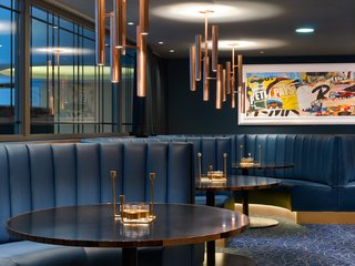The Largest Hotel in Paris Gets a Midcentury Modern Update - Photo 5 of 5 - Varied seating options in the hotel's Jazz Club Etoile include leather banquettes; a new row of windows lines an interior wall to evoke an urban feel.