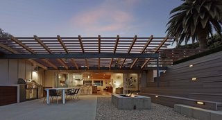 "The rear yard, given the property's limited size, presented more of a conundrum," says Southerland. "We came up with the idea of using the roof of the garage as a roof deck to add useable area to the rear." Taking advantage of the gently sloped site, he built a series of terraced bleacher-style seating above and around the detached garage, doubling its roof as an additional terrace, and effectively bridging the backyard space into one multi-level whole.