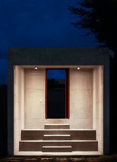 Detached from the main structure, a stepped entryway leads into the property.