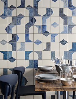 A closer look at the hand-painted, ceramic tile fresco on the ground level of Belle Maison. Bonaventure also specified ceramic dishes and tableware from Broste Copenhagen; the Nemea chairs are from Pedrali.