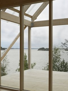 The roof portion made of corrugated fiber-reinforced plastic hangs above deck, which measures roughly 215 square feet and overlooks views of the water.