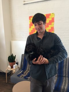 Good Thing founder Jamie Wolfond holds office mascot Arthur in the Brooklyn office of his manufacturing brand, Good Thing.