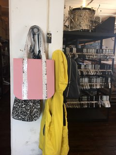 A paper prototype for a new tote bag incorporates the brand's speckled logo.
