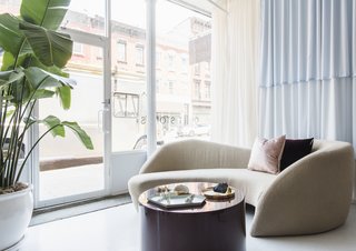 A sinuous Preview sofa by Vladimir Kagan for Weiman greets visitors to Brooklyn jewelry boutique Quiet Storms.