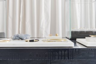 "The details of the table design are a counterpoint to the fine jewelry and accentuate the beauty of each piece," Roberts says of the hand-dyed Scout + Gather creations, which are dyed a rich blue-black and feature rough plywood edges with intentionally dripping paint.