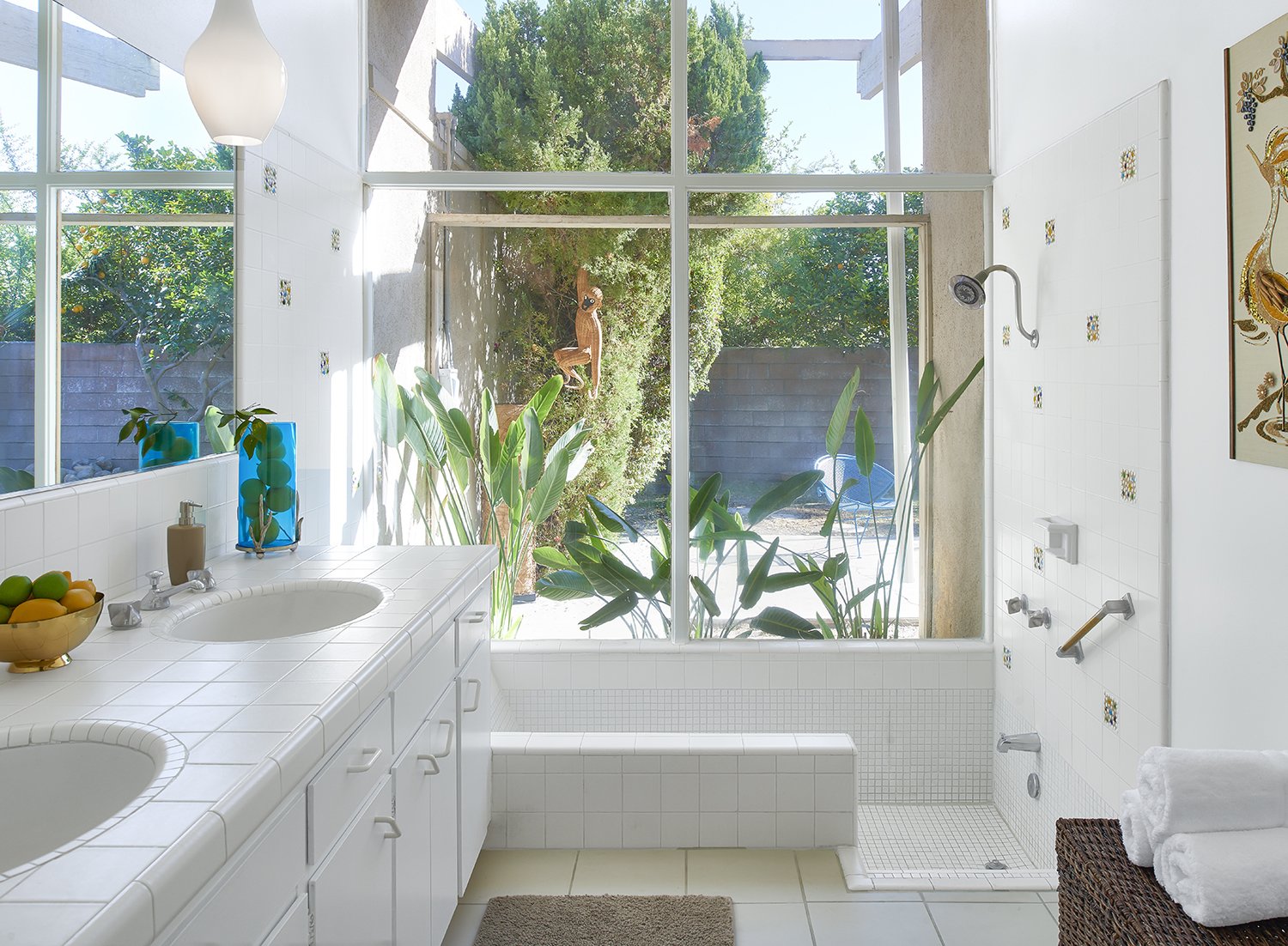 The Jungle bathroom at the Monkey Tree hotel in Palm Springs. Accessories and art like the roadrunner needlepoint wall hanging were largely "made by regular people and found in vintage stores," Kathy says.