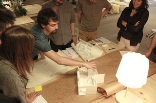 The ENORME Studio team works with a model to develop the Home Back Home #03 prototype project.