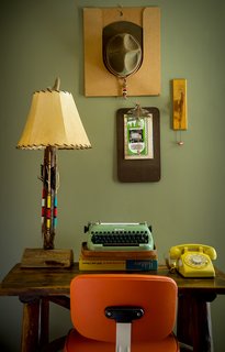 The carefully organized workstation is a nod to scoutmaster rooms, complete with a traditional office chair, antique Adirondack desk, and antique troop leader's hat. 