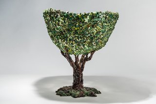 The tree vase is the result of a mosaic or decoupage technique in which pieces of resin were collaged on the surface to mimic foliage. "When you have new possibilities your ideas become more at reach," Pesce says. 