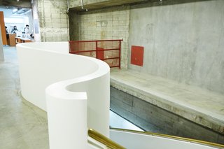 A Surprise Hides in this Tokyo Parking Garage - Photo 3 of 6 - A sinuous stairway, one of a few architectural interventions to the raw concrete garage space, leads to the second floor.