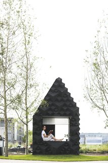 The Urban Cabin includes a sofa that doubles as a twin bed, a small porch and amble glazing.
