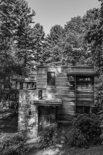 The stone and wood structure was designed to complement with its surroundings. Here, the Douglas fir tongue-and-groove boards are arranged horizontally, elsewhere on the original facade they were aligned vertically. 