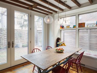 Dark beams contrast the glazing that fills the dining area with light, continuing the home's historic/modern mix. 