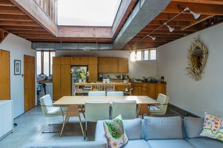When renting an apartment in Frank Gehry's Spiller House, Kristin Grant Fowler and William Fowler chose simple furnishing that relate back to the architect’s humble material palette. The tabletop is set on Burro Brand saw horses—the same ones Gehry uses in his office. The sofa was designed by Kristin's grandfather, Park Avenue interior designer Hector Grant; the mirror was also a gift from him. The cushions are by Josef Frank.