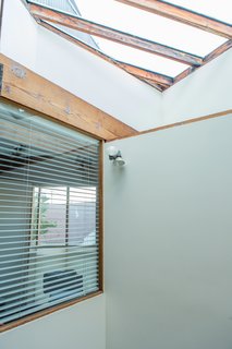 "The light from the light well is so beautiful during the day," resident William Fowler says. "And even though the house is a block from the boardwalk (ground zero for Venice weirdness), it's peaceful." Shielded from from the street by its corrugated-metal siding, the house opens up vertically thanks to the skylight. 
