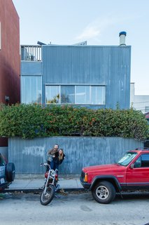 William Fowler and Kristin Grant Fowler of Dust to Dust Furniture outside their home in Frank Gehry's 1980 corrugated-iron Spiller House in Venice Beach, California. 