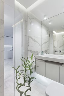 In the bathroom, marble walls provides a sleek backdrop.