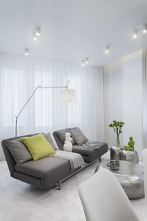 All In Studio designed the custom furniture, in complementary gray, to be modular, flexible, and functional. When unfolded, the sofa doubles as a bed.