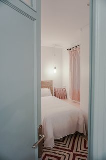 The original doors were salvaged and given a fresh coat of blue paint. The resident brought many of the rugs were from Egypt.