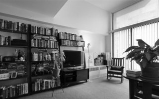 A bulky shelving system once occupied an entire wall; now a streamlined cabinet system stashes belongings. The architect replaced the radiators with a slim wall-mounted option.