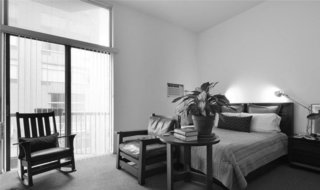 Before the renovation, the living room was dominated by the bed, limiting the functionality of the space.