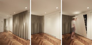 A built-in track allows the KnollTextiles curtains to be moved in front of the entrance, creating a cozy bedroom space. A queen-size Häfele Murphy bed is hidden between two sets of Poliform cabinets.