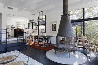 Besides the view, the home's most dramatic element is a fireplace built from a gear from an old oil rig. To keep up with code regulations, the Hogans added a concrete base, which they customized with text celebrating the year they moved in. 
