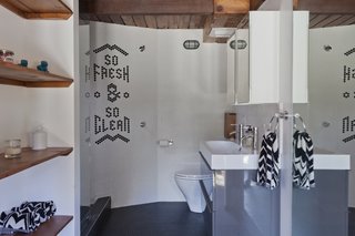 Chad looked to his experience in graphic design when creating his family's home. Elements of text and graphics can be found throughout, including the inlaid tiles that spell out "So Fresh & So Clean" in the guesthouse bathroom.