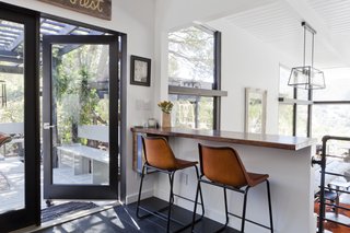 Reorganizing the kitchen and dining area was a key point of the renovation. Now it's an open space that links to the deck, which the family uses as an outdoor living space. 