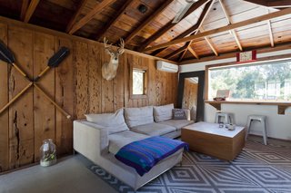 Though brightening the house was a top priority, the couple kept the original cedar cladding and raw redwood ceiling in the guest house as a nod to the home's original style.