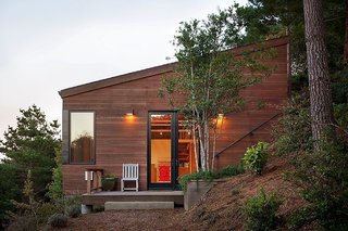 The View at This Art Studio Could Inspire a Masterpiece - Photo 2 of 3 - The approximately 1,800-square-foot studio is clad in redwood to match the ochre terrain; its angled roof defers to the hill's incline. The windows are from Blomberg Window Systems. 
