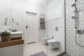 Rarely Do Family Homes
Look So Raw - Photo 3 of 3 - Subway tile, another fixture of the urban landscape, envelops the bathroom. 