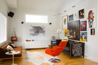 Lori Andrews and Ken Corner continue to add furniture to their Calgary home. The black leather Montauk sofa was the first piece Lori ever bought; the orange Pierre Paulin Tulip lounge chair was a birthday gift to Ken. 
