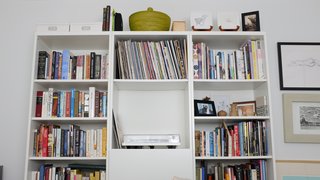 An IKEA shelf in the guest room displays an Orbit Turntable by U-Turn.