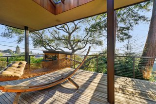 A Quintessential Midcentury Home Goes LEED Platinum - Photo 5 of 5 - The home’s deck extends outward toward a vista. General contractor McCutcheon Construction was tasked with improving insulation and installing double-pane windows throughout. 
