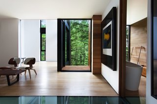Is it Any Surprise a Sculptor Had a Hand in This Home? - Photo 3 of 4 - The home’s lower volume frames majestic woodland views. The LCW Chairs are by Charles and Ray Eames. 