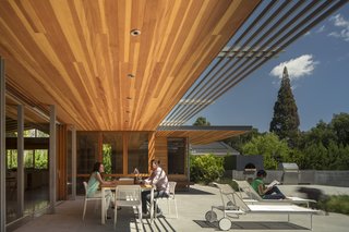A wall of sliding glass doors collapses the divide between inside and outside. 