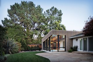 Cling to Summer a Little Longer at This Indoor Oasis - Photo 3 of 3 - The geometric addition, with its cedar rain screen, is joined at the hip with the more traditional residence.