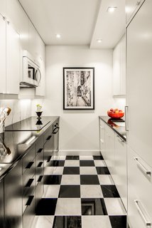 After Sandy, an NYC Designer Rehabs His Ruined Apartment—and Lends Neighbors a Hand with Theirs - Photo 2 of 4 - The 650-square-foot apartment has a galley kitchen with checkered black-and-white tile. 