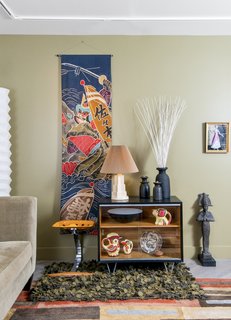 After Sandy, an NYC Designer Rehabs His Ruined Apartment—and Lends Neighbors a Hand with Theirs - Photo 3 of 4 - A living room vignette includes a 1950s batik Boy’s Day banner from Japan, Czech pottery, and a framed costume presentation from the estate of late opera diva Beverly Sills.